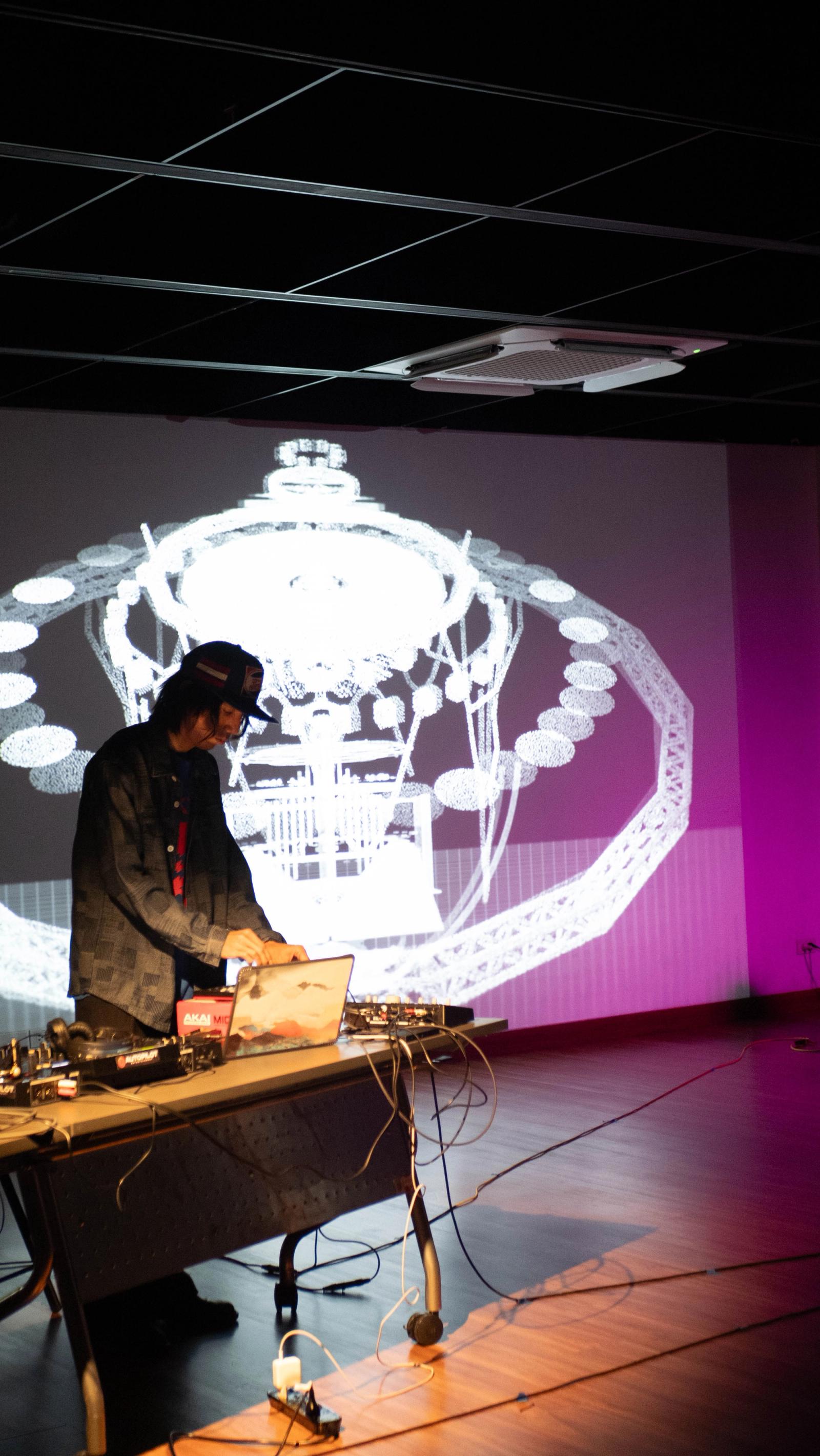 The tower in wireframe behind the performer