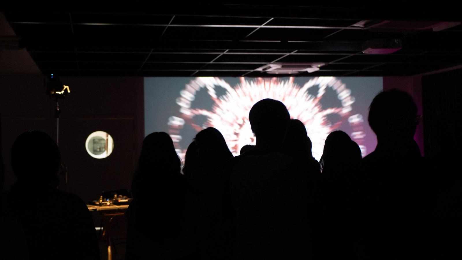 The audience watching the projection
