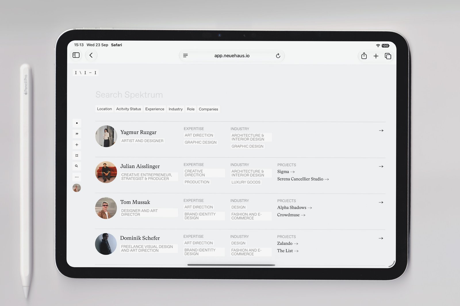 A phone showing a member profile, laid out with a pencil and two cards.