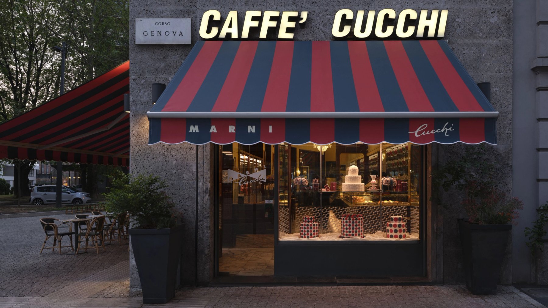 The front of Caffe Cucchi in Milan, under its red and blue striped awning.