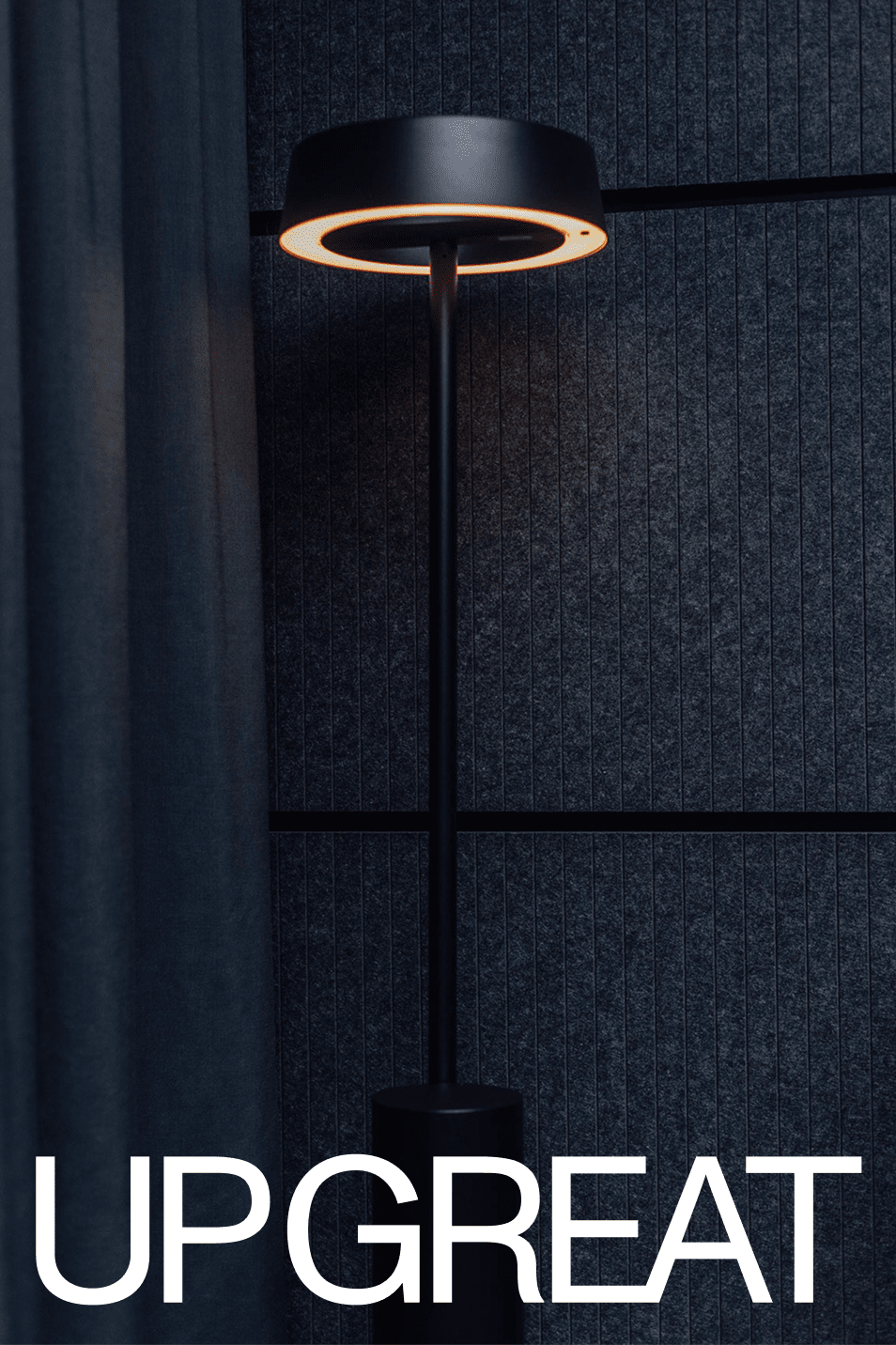 A black floor lamp against a dark panelled wall, under the UP GREAT name.