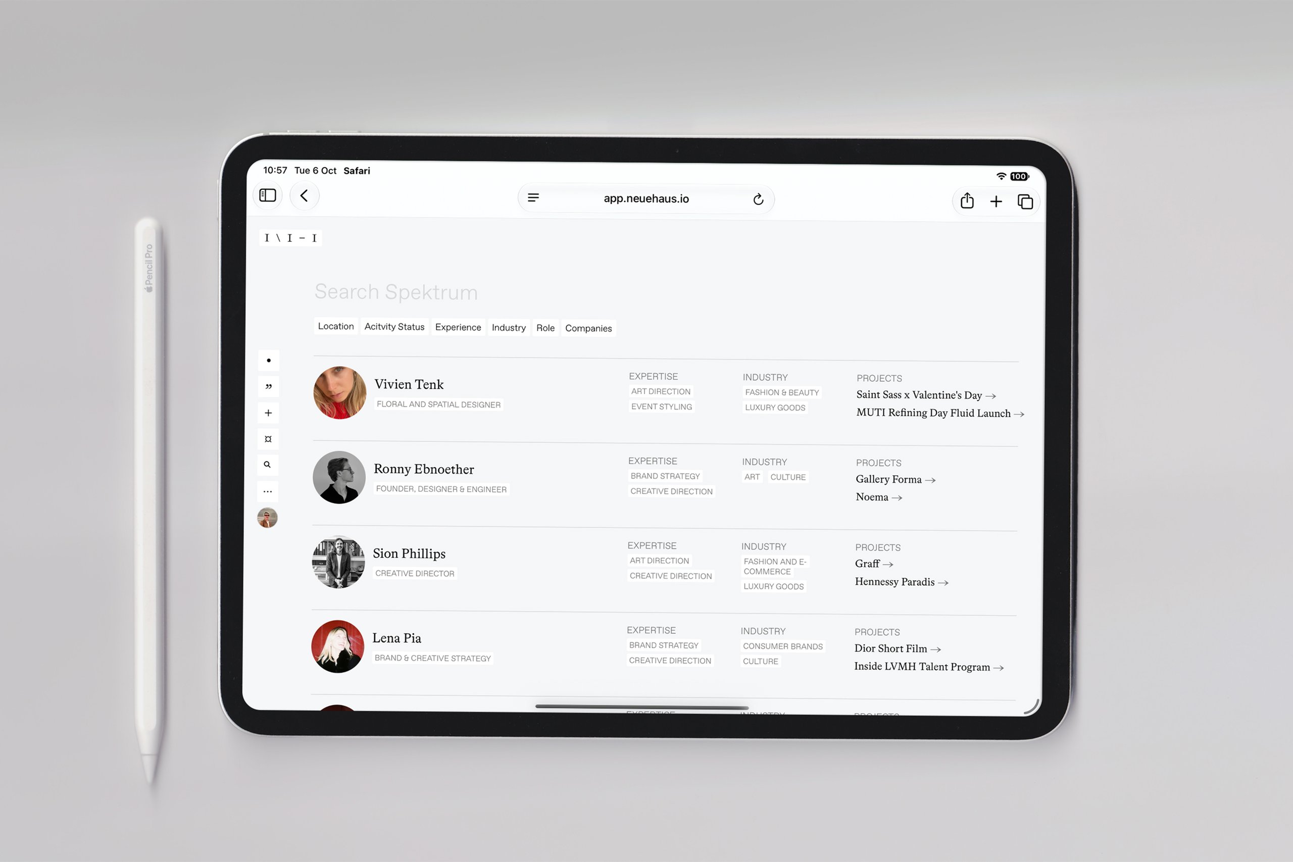 A tablet showing a share sheet of members, with a pencil beside it.