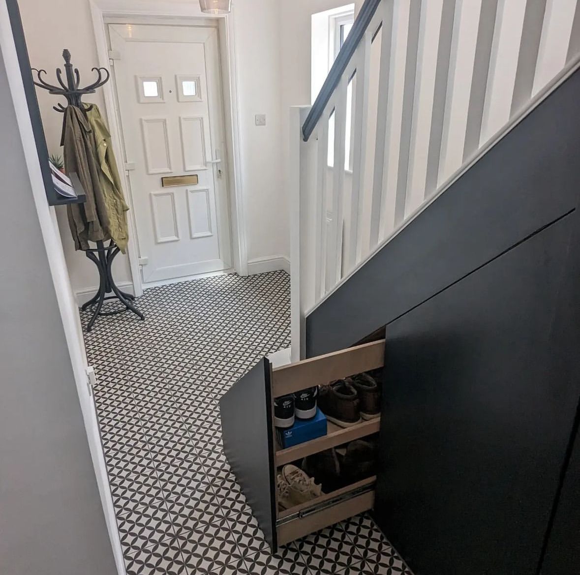Image of built-in multi rack show drawer that pulls out of staircase