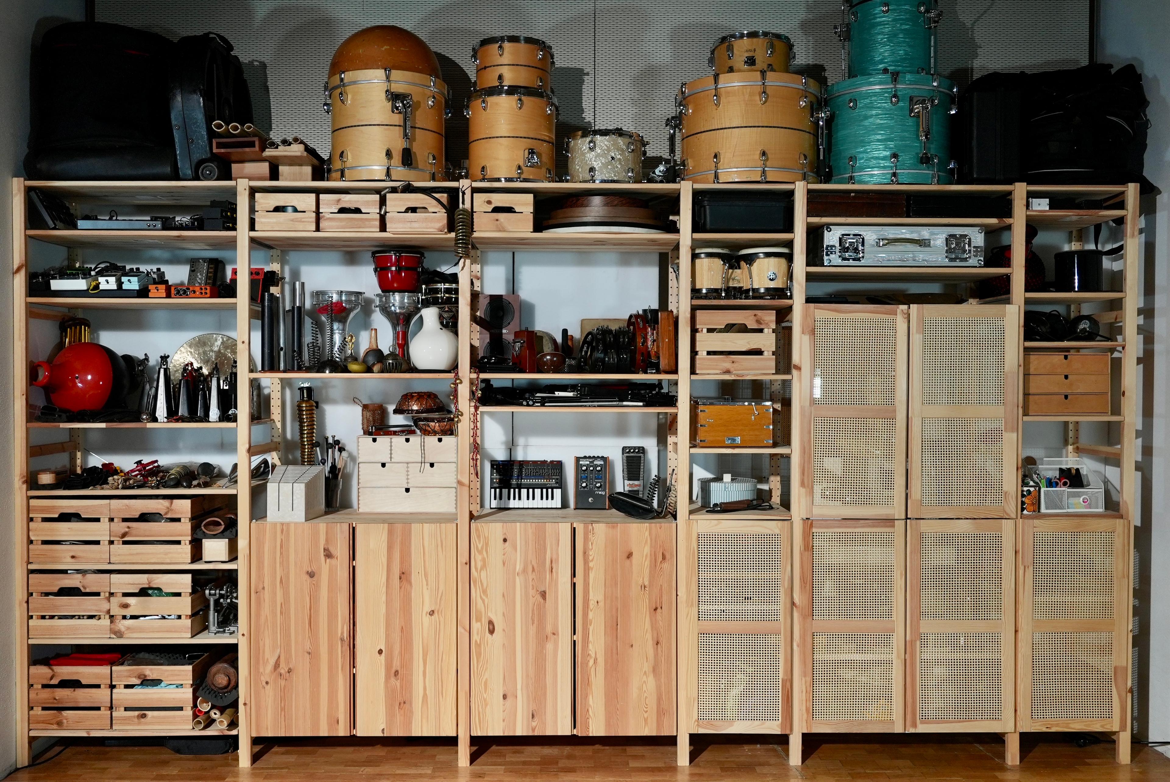 Cupboard in Simon Popp's studio full with percussions, drums and electronics