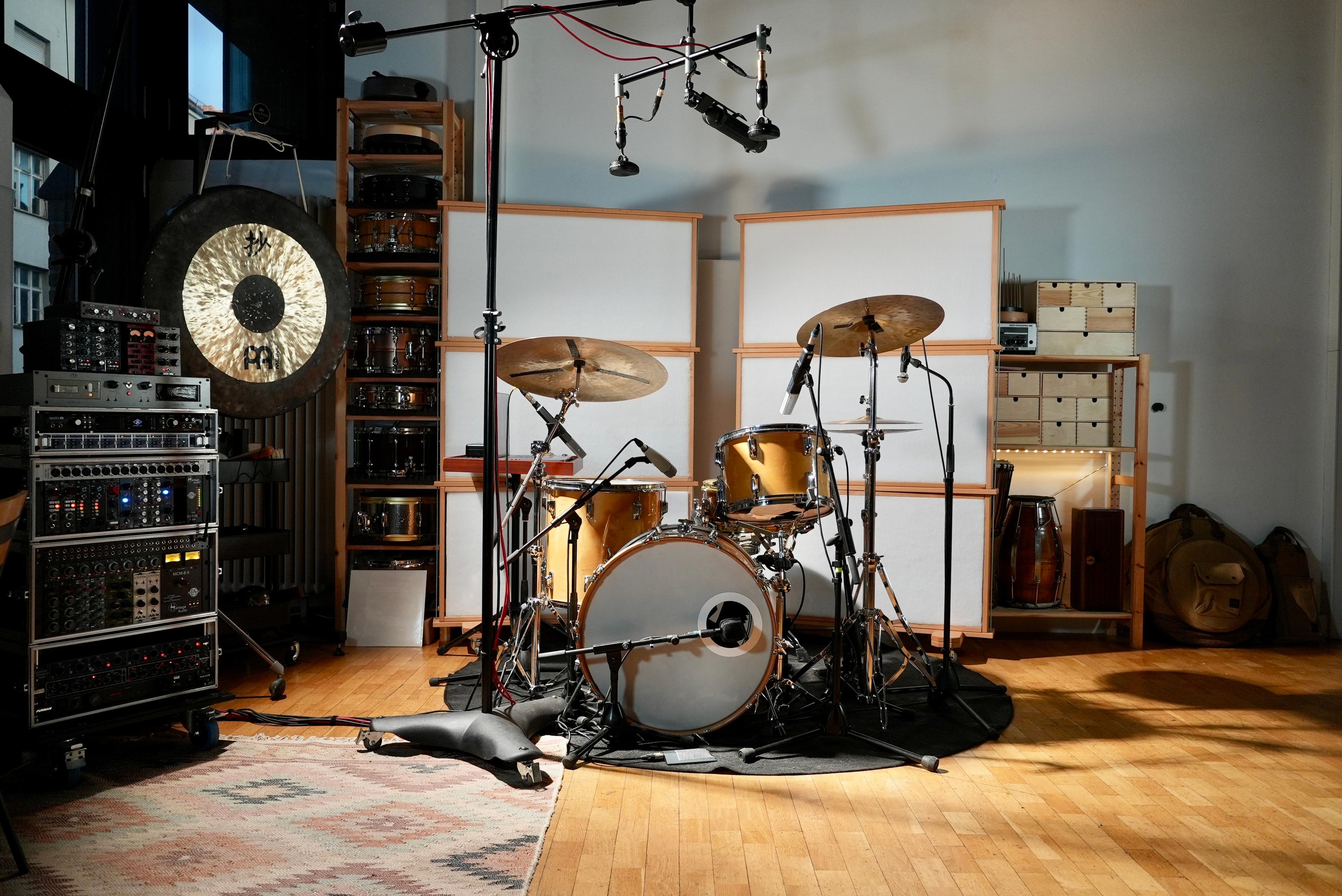 Music studio of Simon Popp with miced drumset snares and a gong