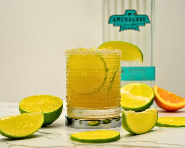 Classic margarita surrounded by limes and Ameragave Silver