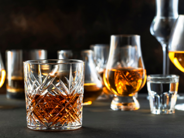 Different sizes and types of sipping glasses with different types of tequila in each one.