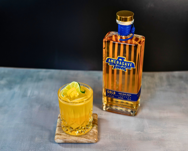 Margarita glass with limes sitting on a wooden block