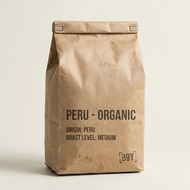 A specialty coffee bag labeled 'Peru - Organic' with a medium roast level, photographed against a bone/off-white background with diffused lighting.