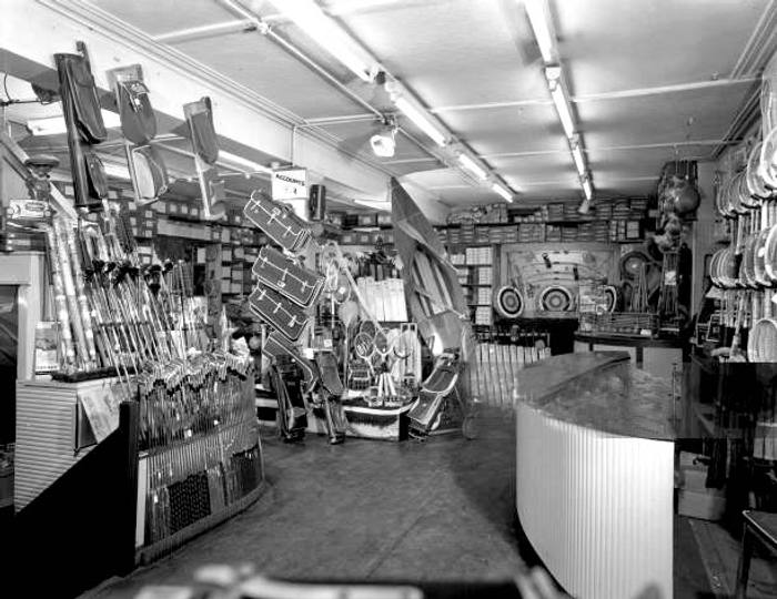 Sugg's sports shop interior, Sheffield, South Yorkshire, 1961. The interior of Sugg Sports in Sheffield city centre. The photographs show a variety of sports goods, including archery equipment, golf and tennis equipment and a wooden kyak. (Photo by Paul Walters Worldwide Photography Ltd./Heritage Images/Getty Images)