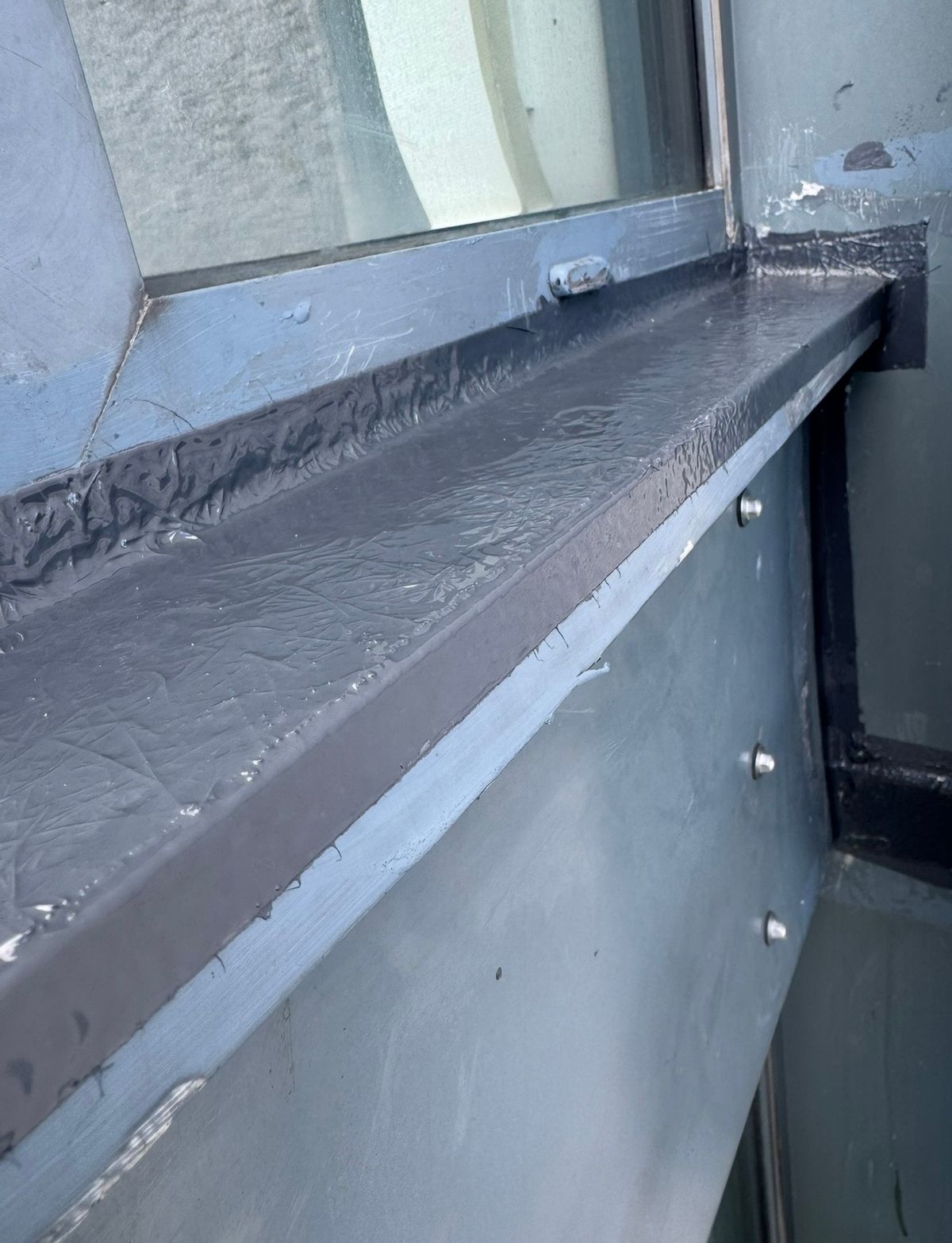 Close-up of the completed window frame resealing following rope access water ingress repairs on a high-rise residential building in Newcastle.