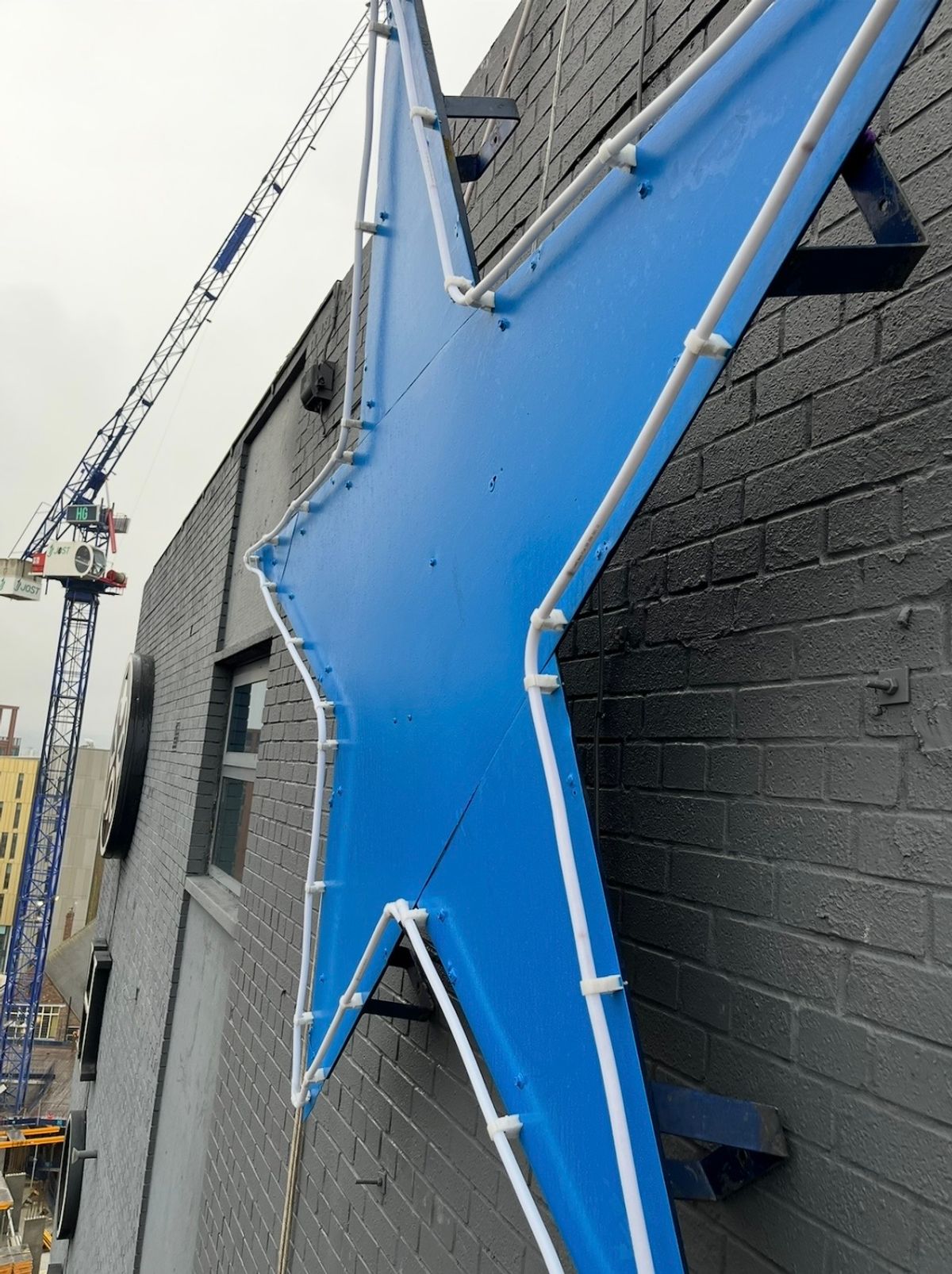 Close-up of the restored Newcastle Breweries Blue Star after repainting, LED lighting replacement and reinstallation at the Sandman Signature Newcastle Hotel.