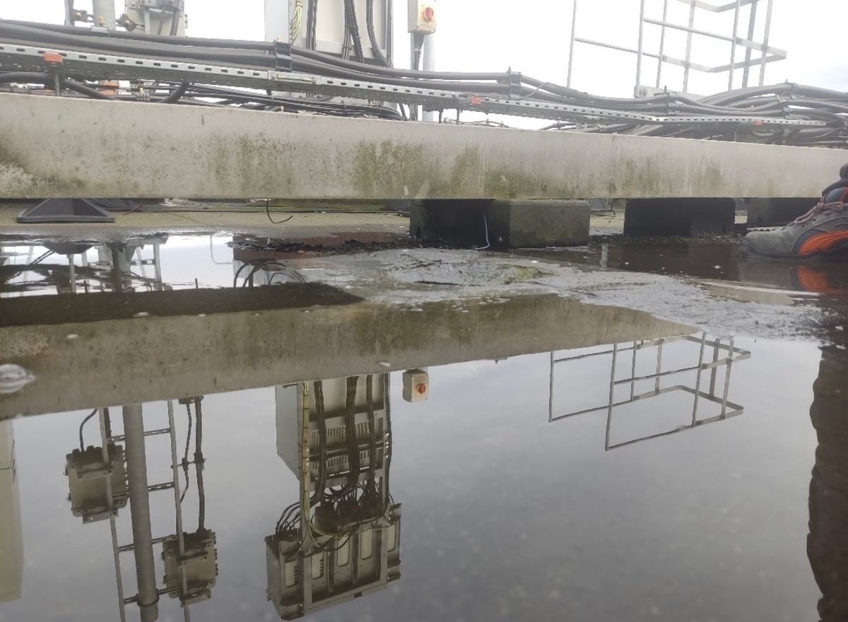 Severe standing water across the weathered commercial flat roof before repair work began.