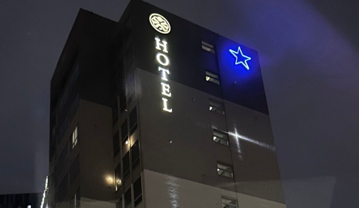 Restored Newcastle Breweries Blue Star illuminated at night following repainting and installation of new LED lighting at the Sandman Signature Newcastle Hotel.