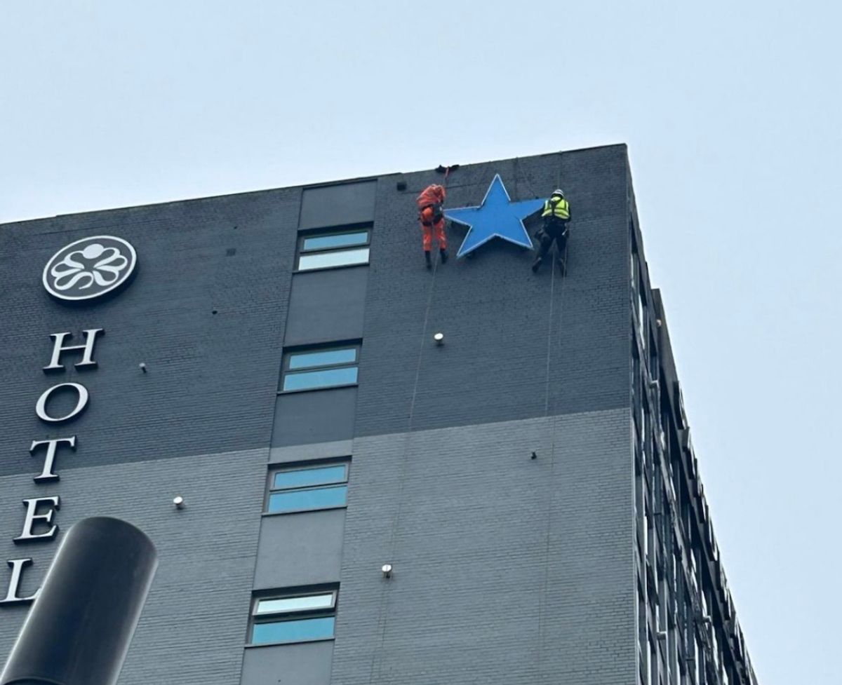 Rope access technicians removing the historic Newcastle Breweries Blue Star high on the Sandman Signature Newcastle Hotel.