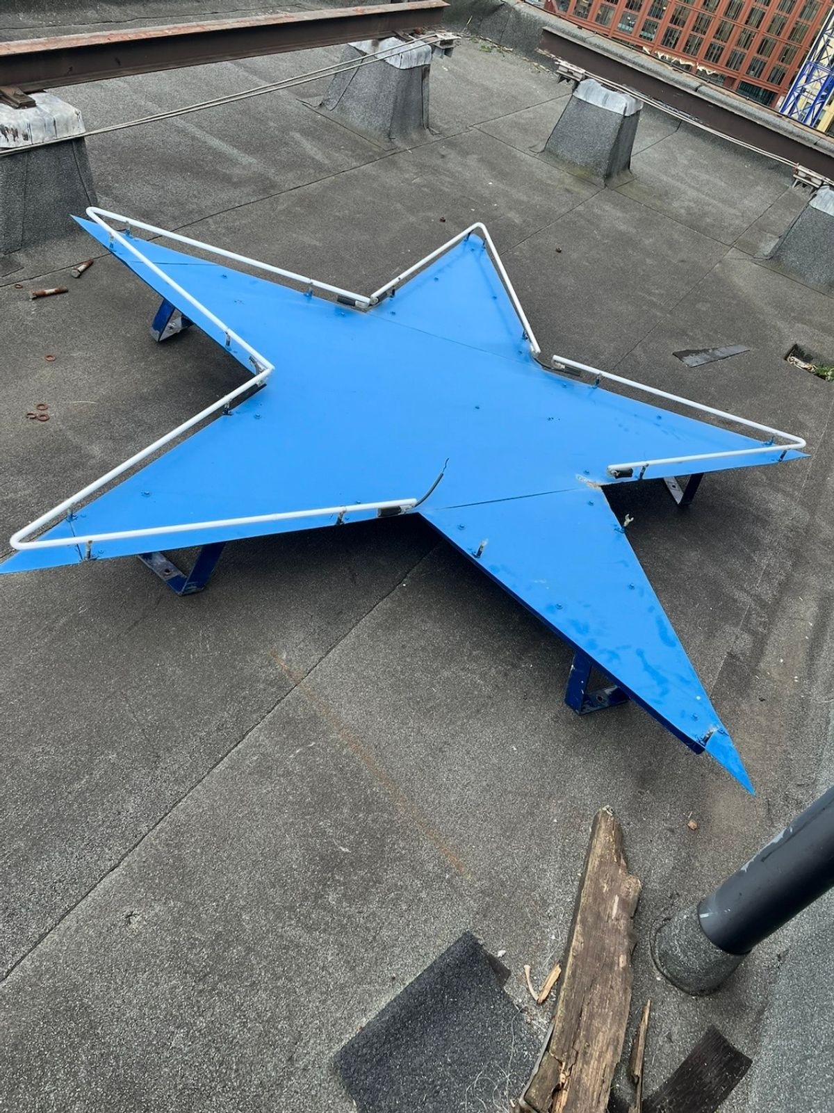 Historic Newcastle Breweries Blue Star at roof level during restoration works at the Sandman Signature Newcastle Hotel.