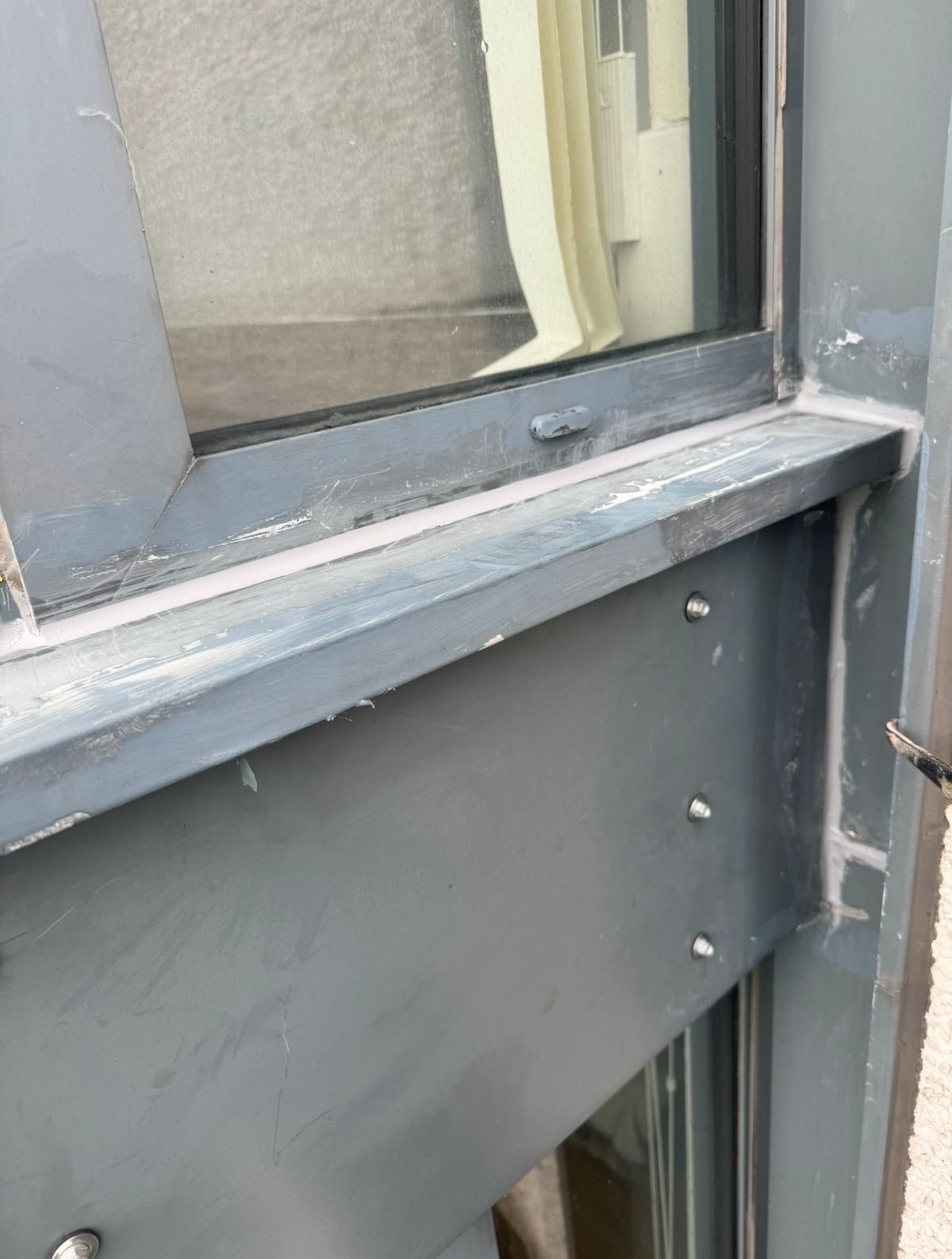 Window frame cleaned and resealed to address water ingress following rope access leak investigation on a Newcastle high-rise residential building.