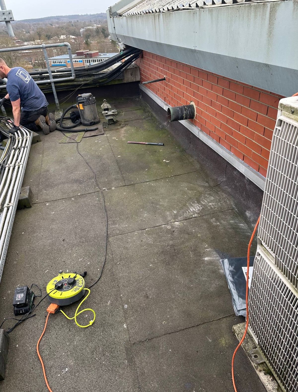 Roof surface being cleaned and prepared.