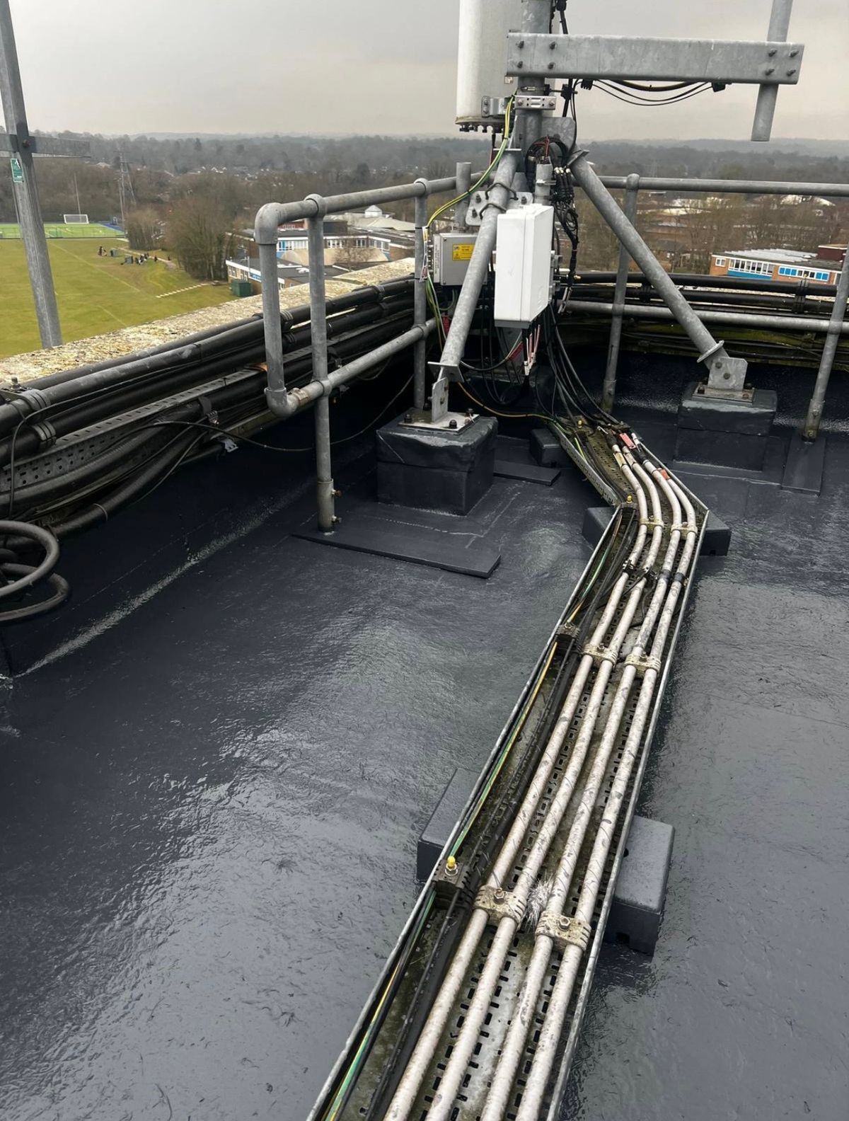 Completed liquid waterproofing around rooftop equipment supports, cable routes and perimeter upstands.