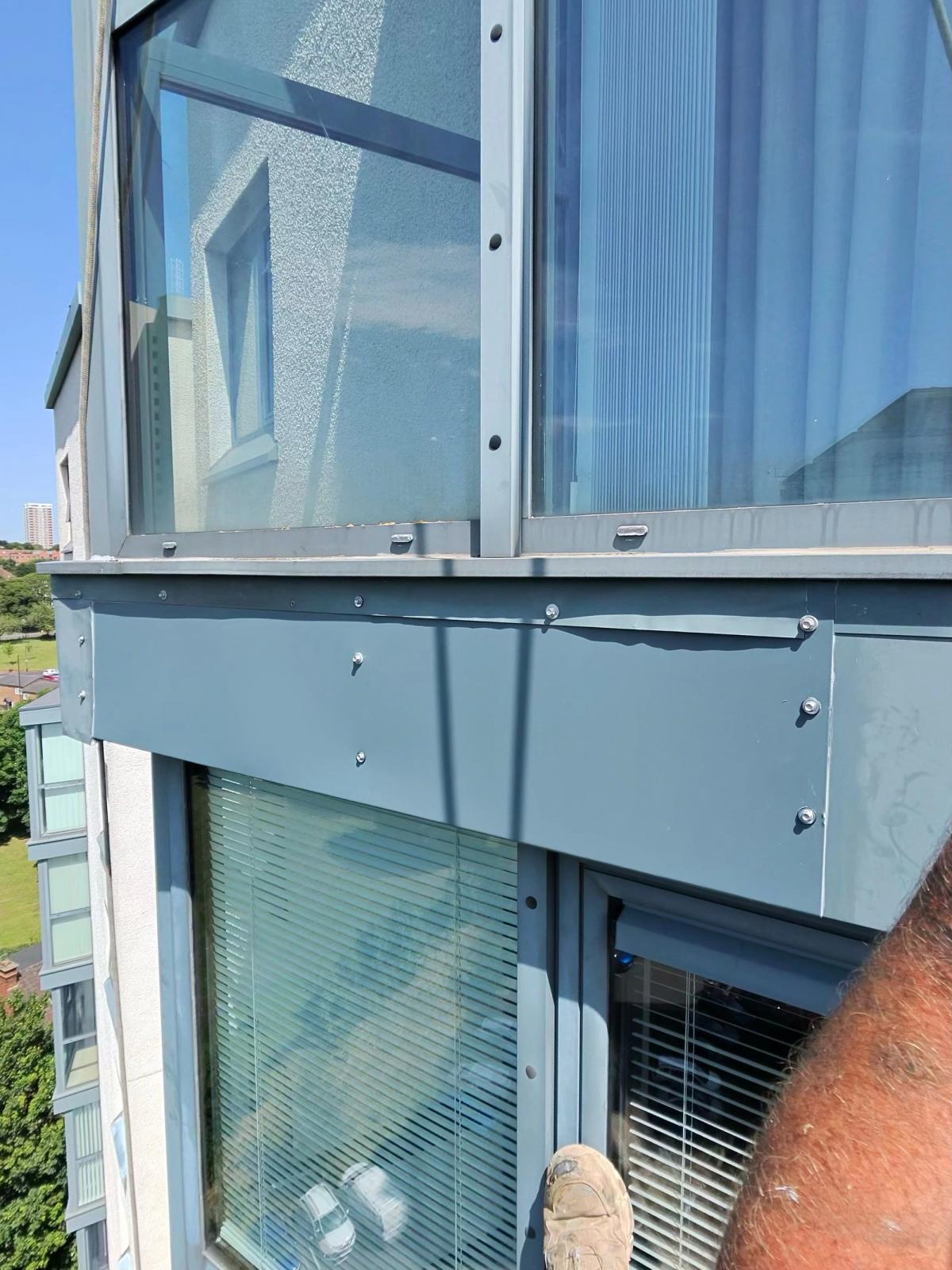 Completed high-level aluminium façade cladding repairs on a residential building in Newcastle, showing reinstated metal panels, mechanical fixings and sealed joints.