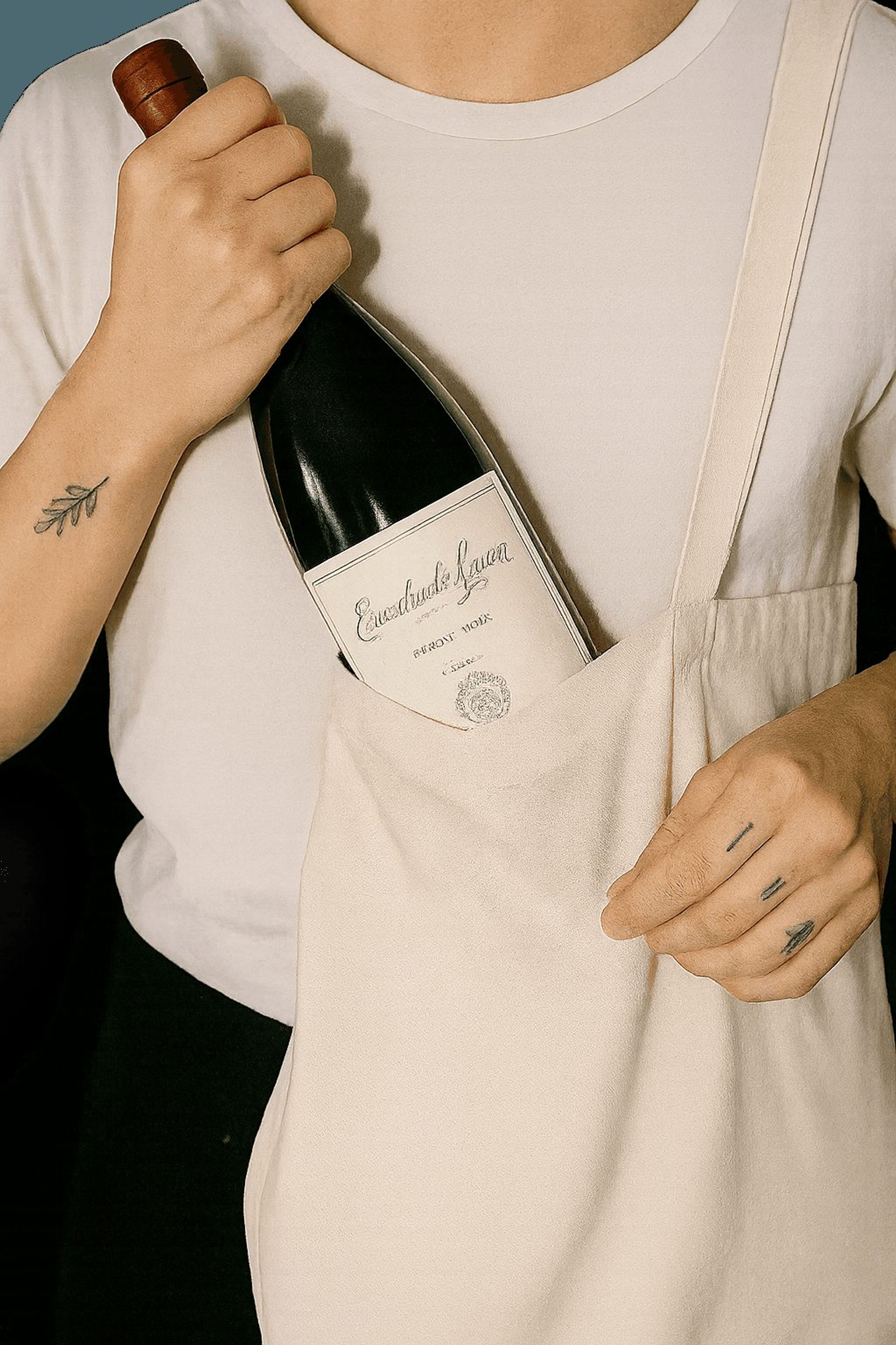 Bottle of red wine sticking out of a canvas tote bag