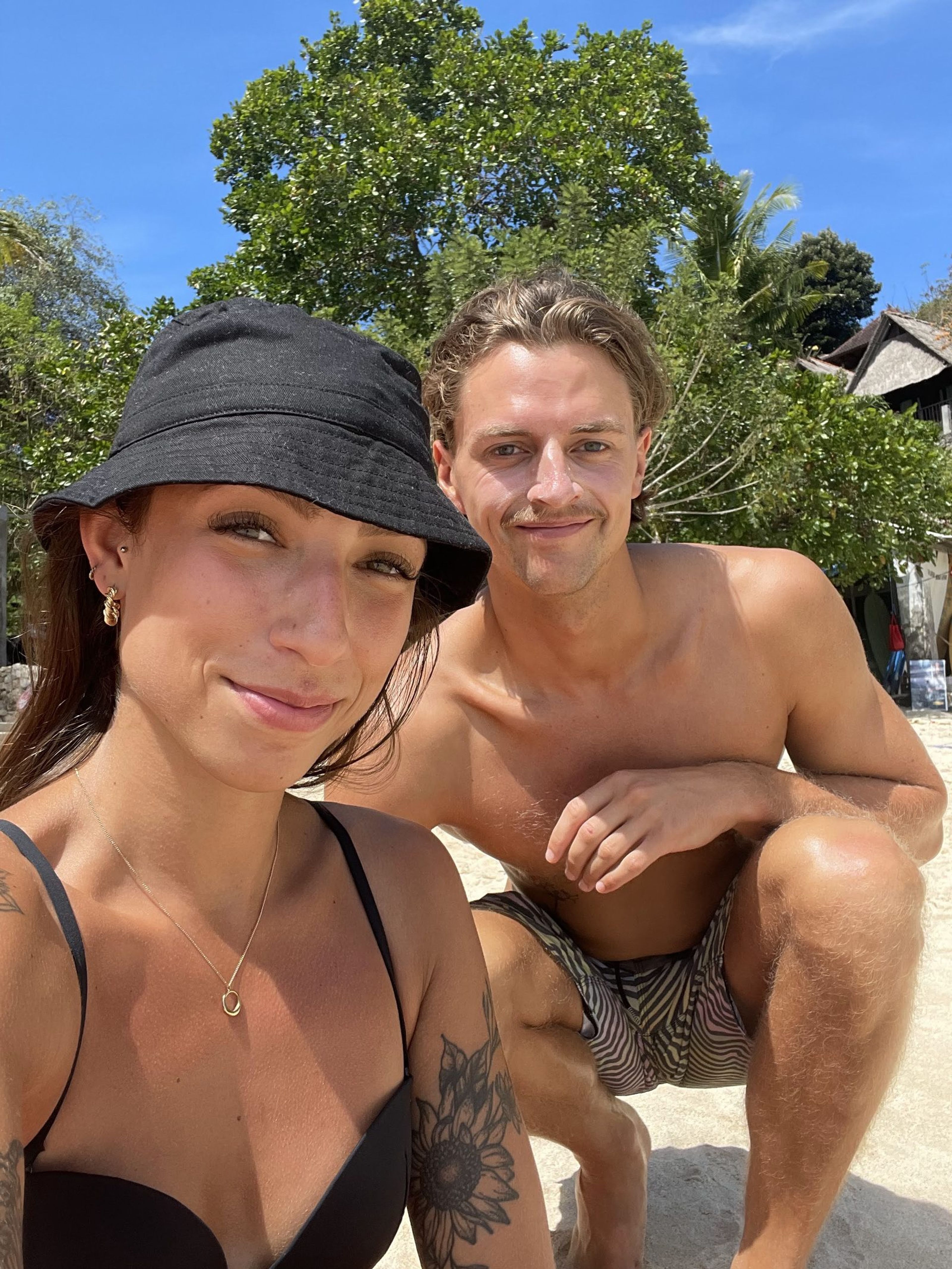Two friends taking a selfie on a sunny beach