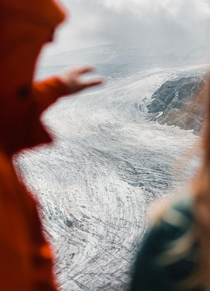 A couple looking out at a glacier