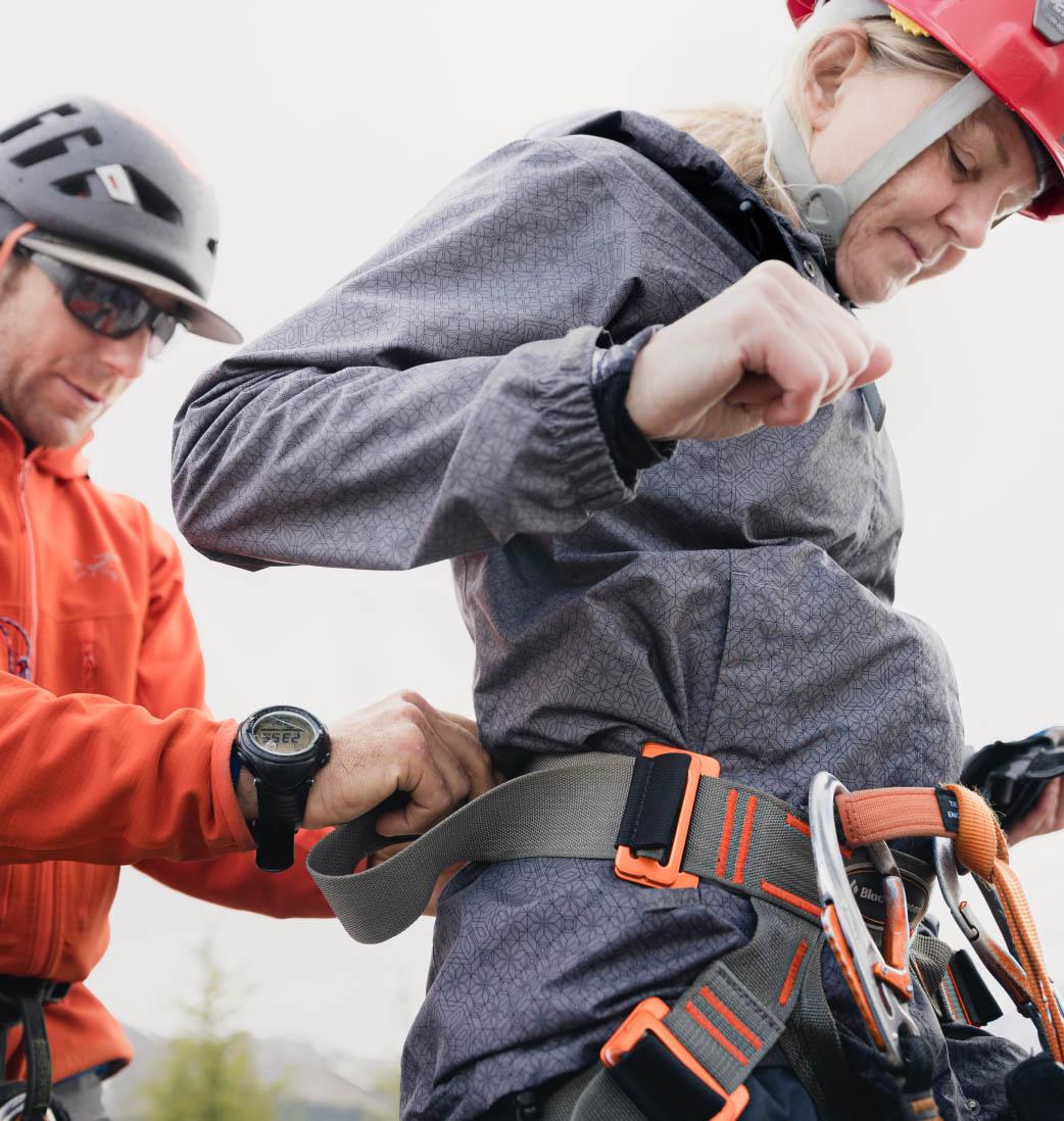 A guest adjsuting her climbing harness