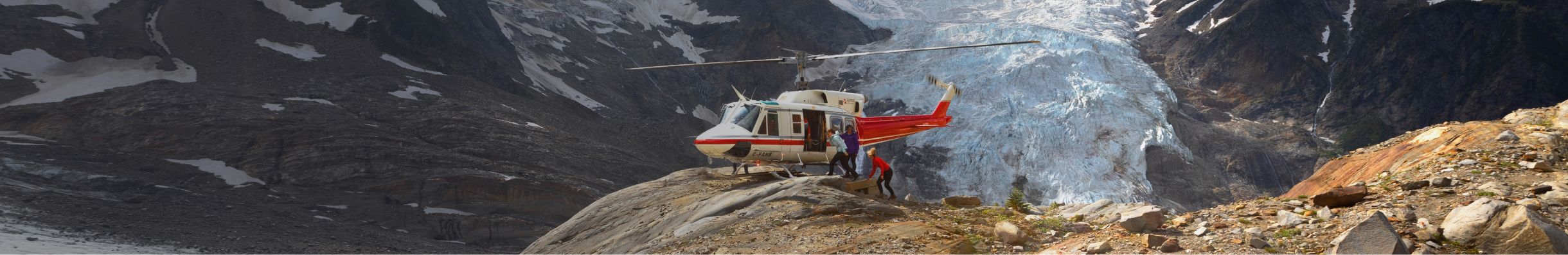 Helicopter landed in front of a glacier.