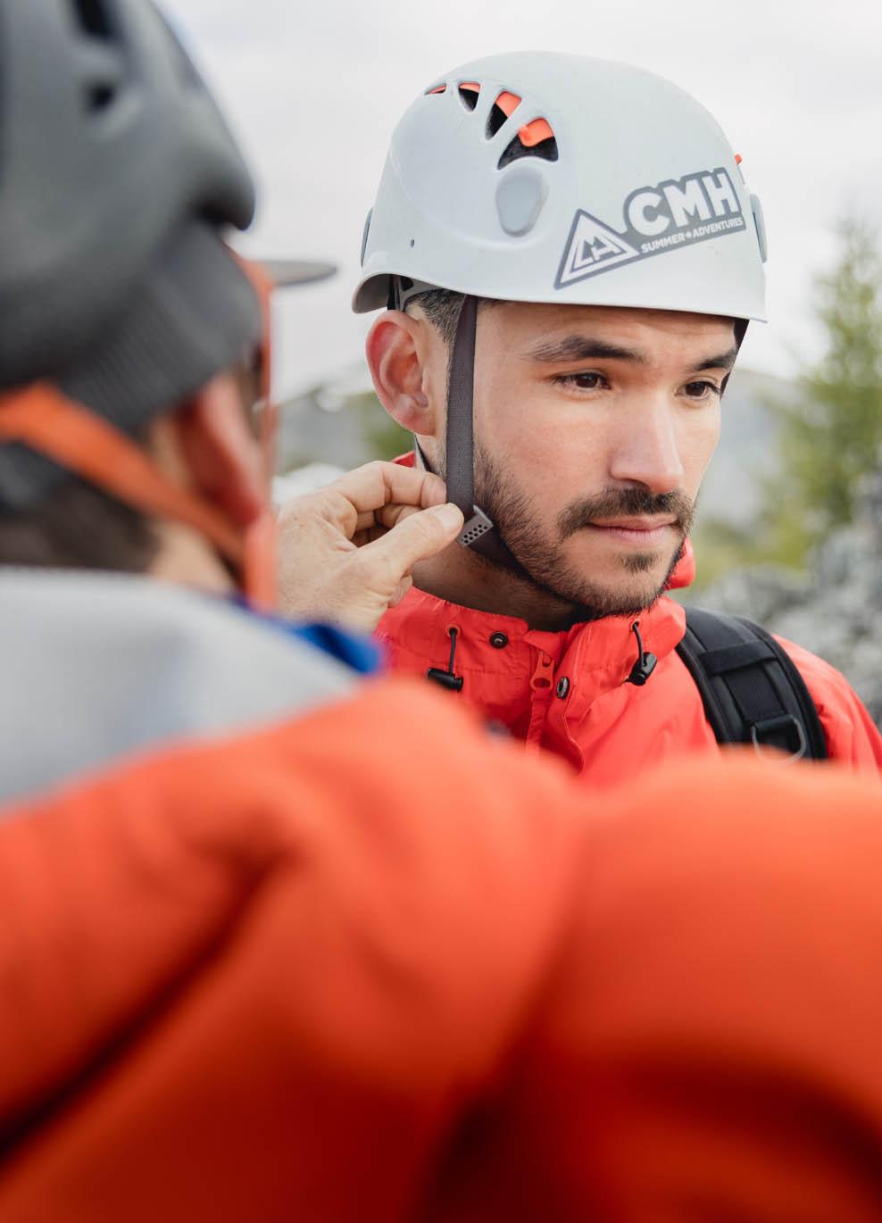 A guest adjusting his climing helmet