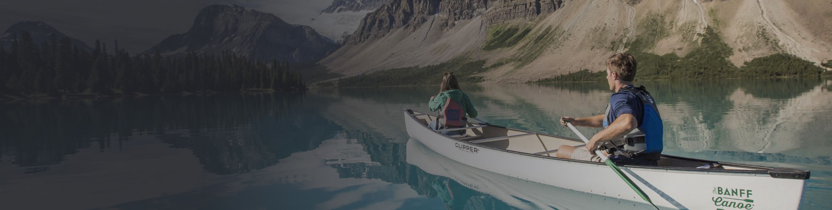 two people canoeing on a glacial lake