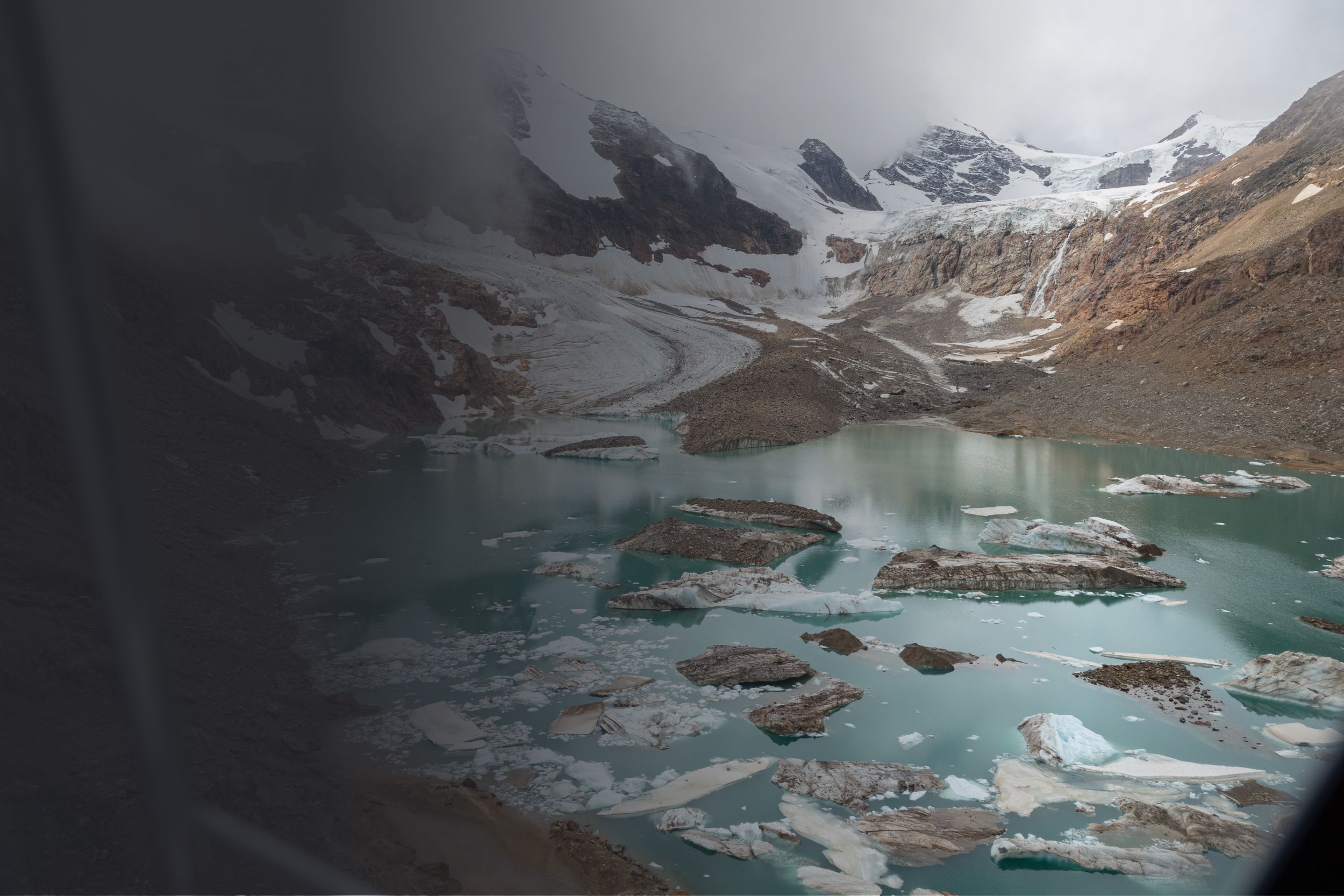 A glacial pond with mountains in the background