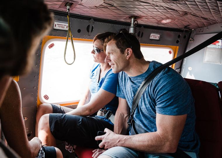Couple looking out the window on a helicopter tour