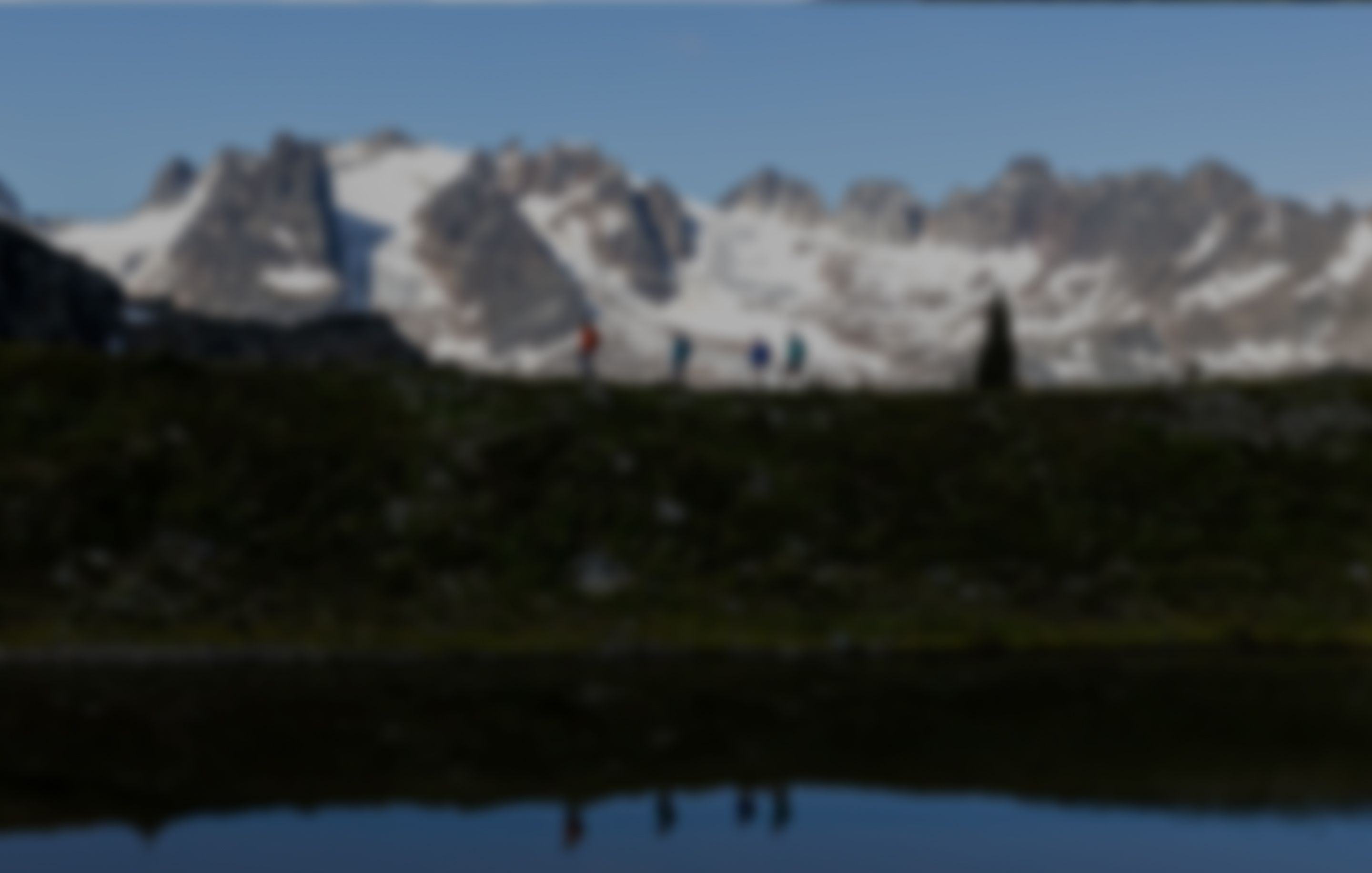 Hikers traversing a mountain ridge
