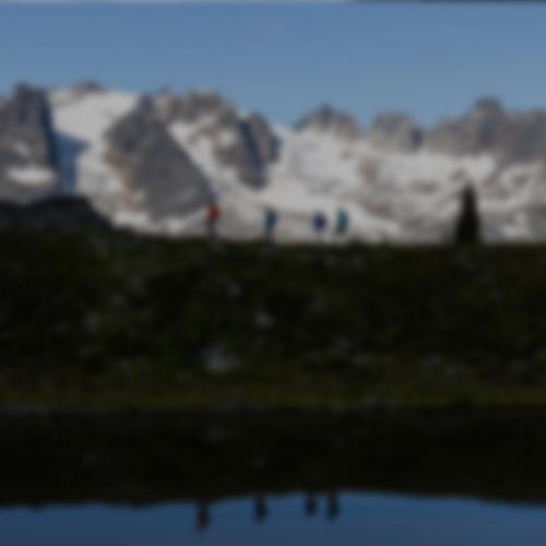 Hikers traversing a mountain ridge
