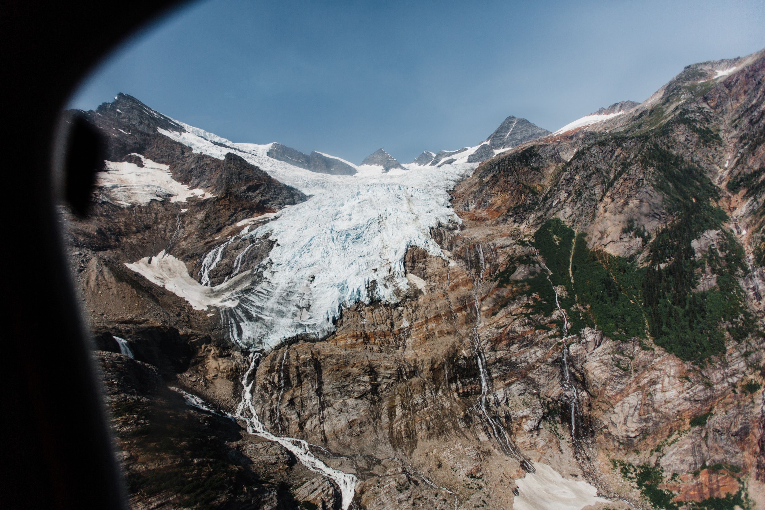 View of a glacier out the window of a helicopter