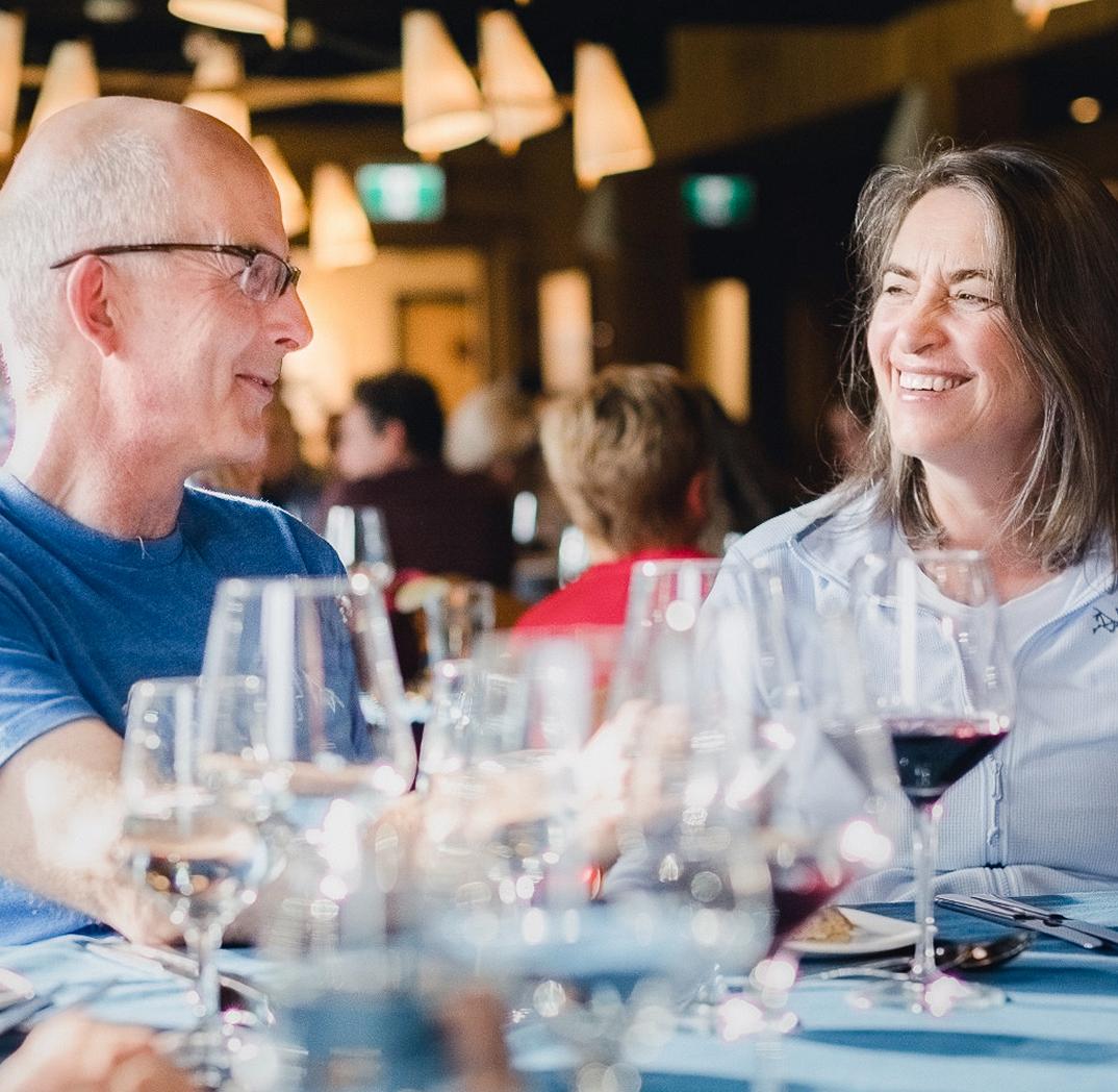 Two people exchange a smile at the dining table
