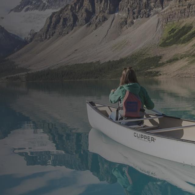two people canoeing on a glacial lake