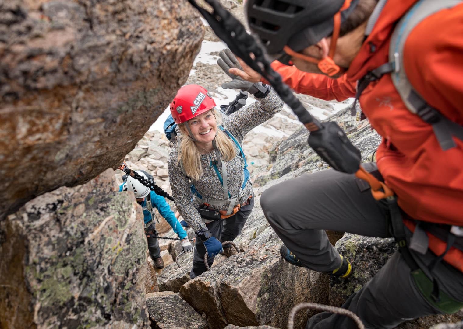 A guide ahead of a group on a via ferrata