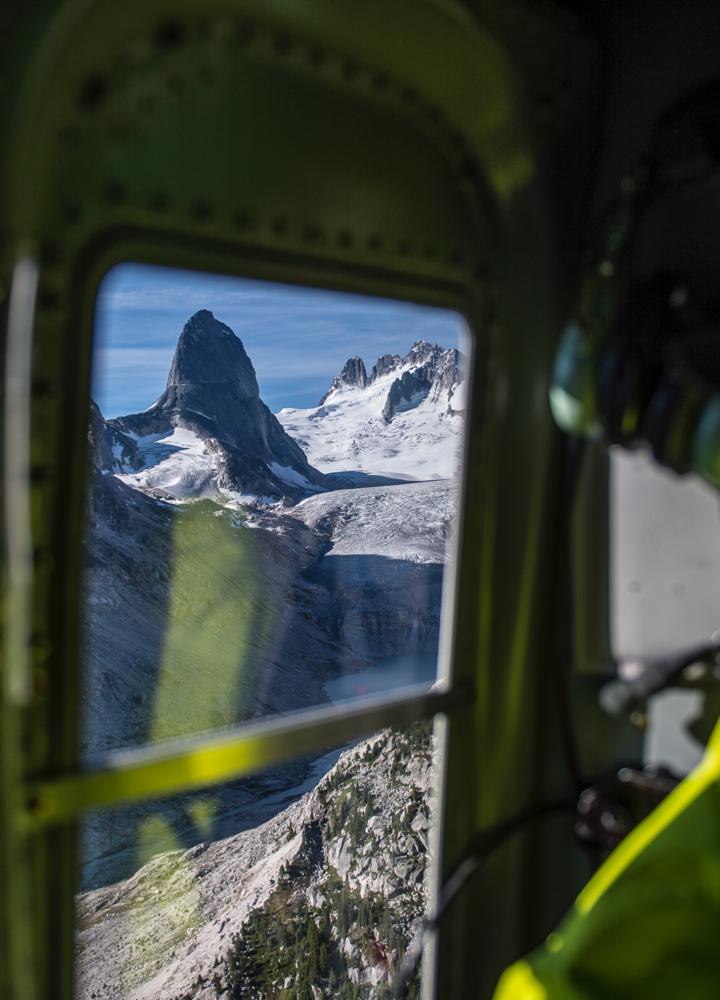 looking out a helicopter window at a mountain