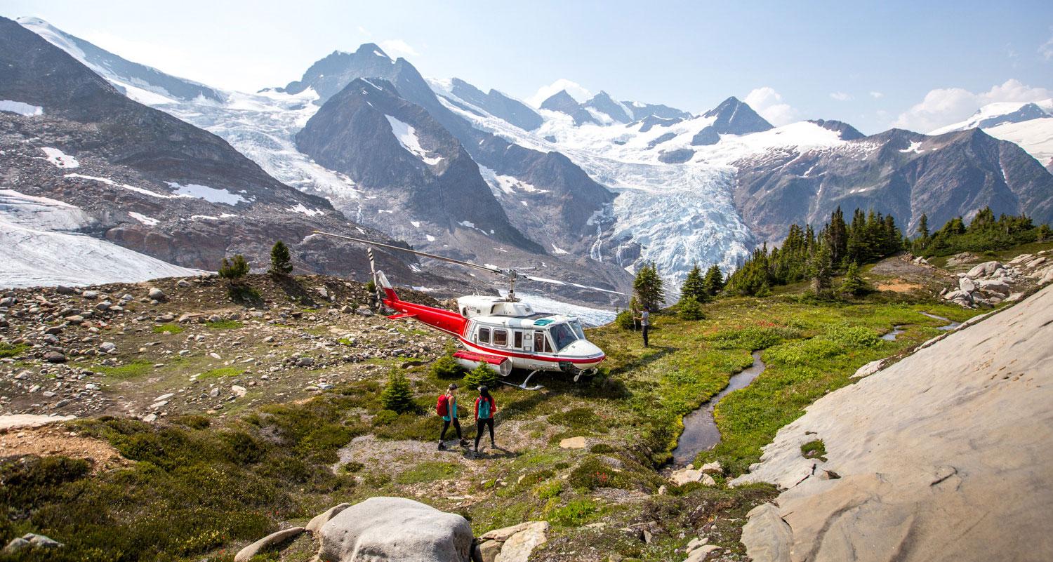 A helicopter parked in a stunning glacial landscape