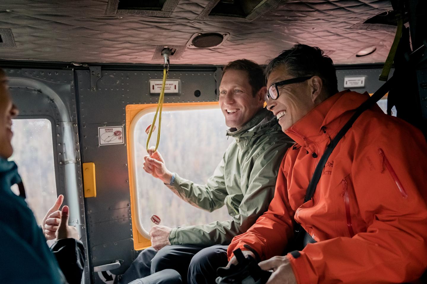 two people smiling in a helicopter