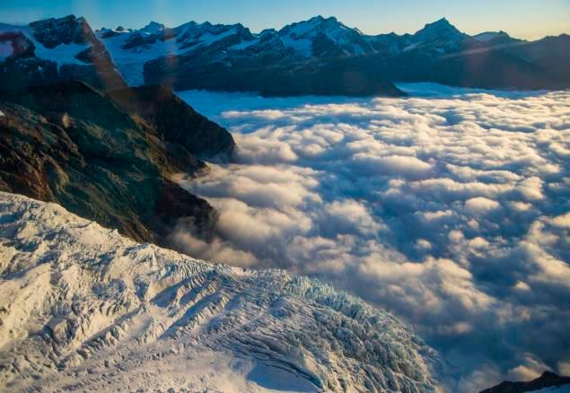 Mountains at sunset with clouds below