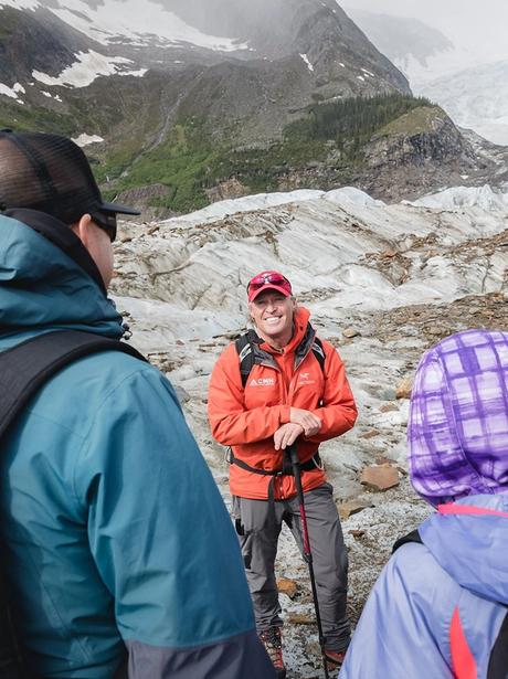 A guide smiling in front of his trip group