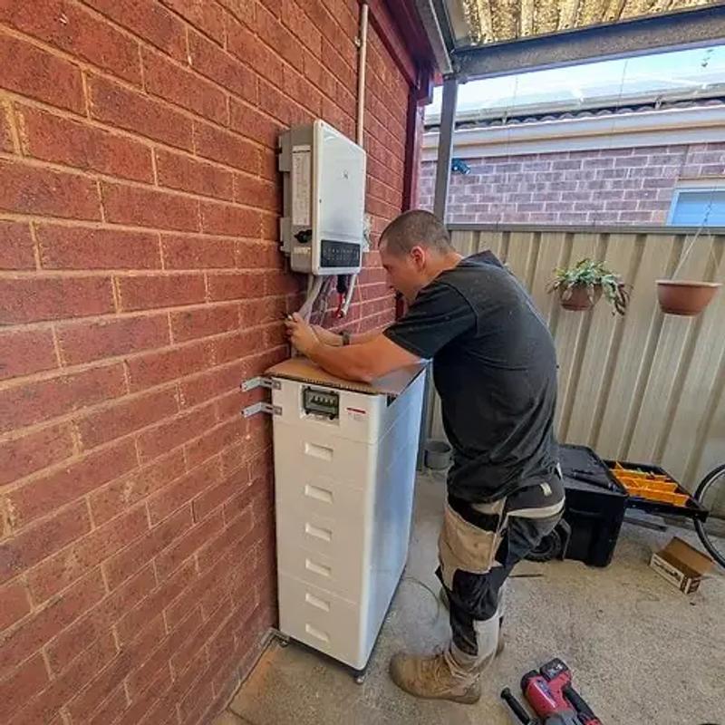 Home solar battery and inverter installed beside a switchboard