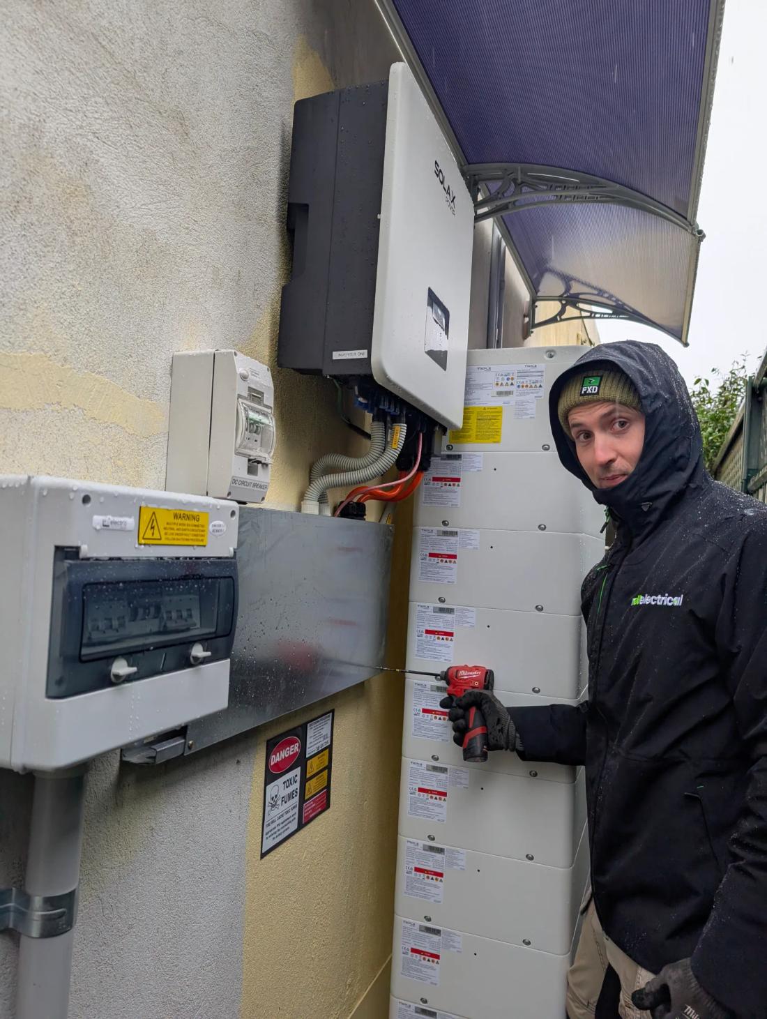 Revelectrical electrician wiring a home battery and inverter