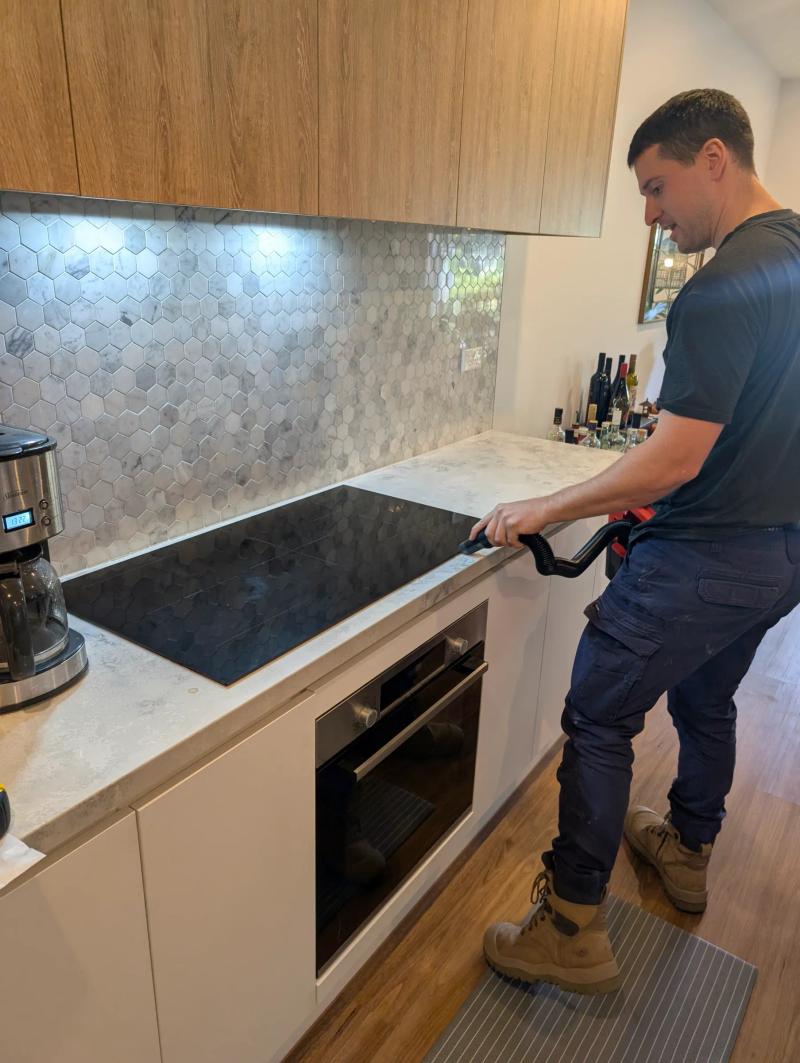 Induction cooktop being installed in a Fitzroy kitchen