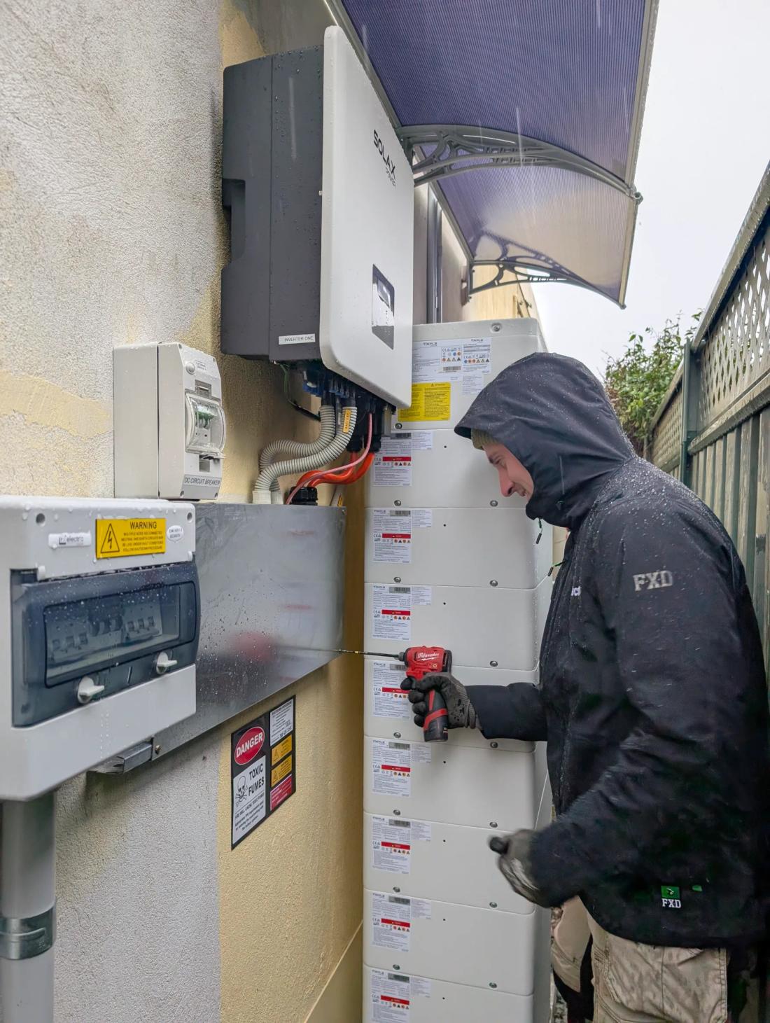 Revelectrical electrician wiring a home battery