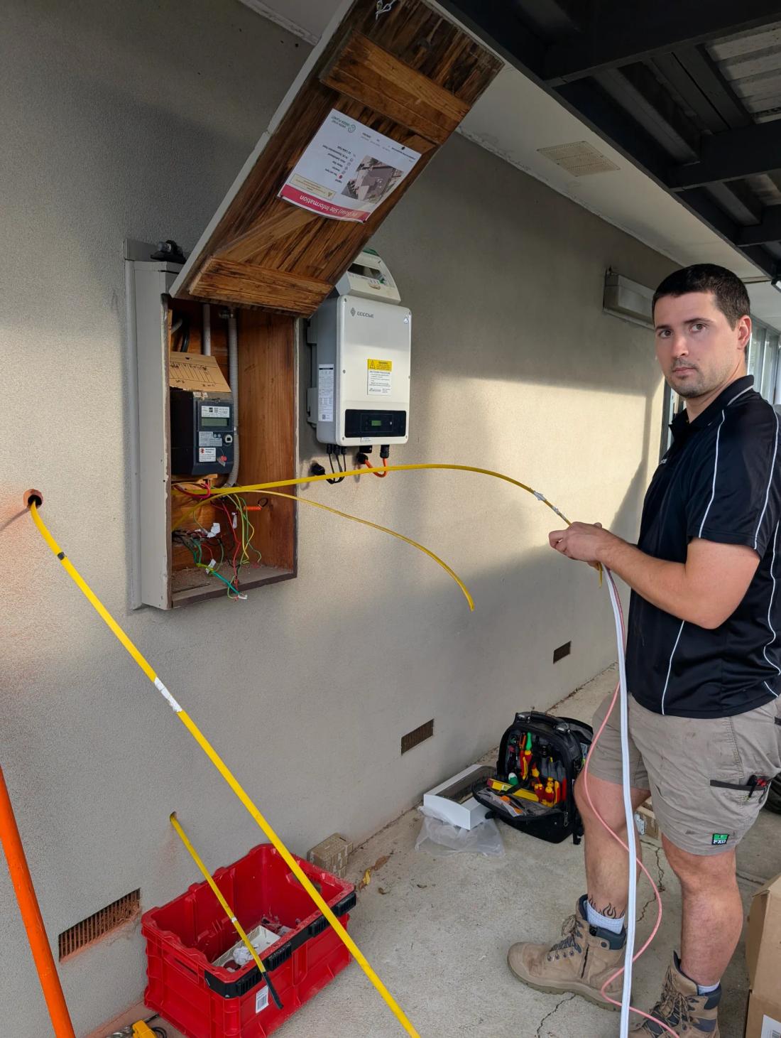Revelectrical electrician running new cable into a meter box