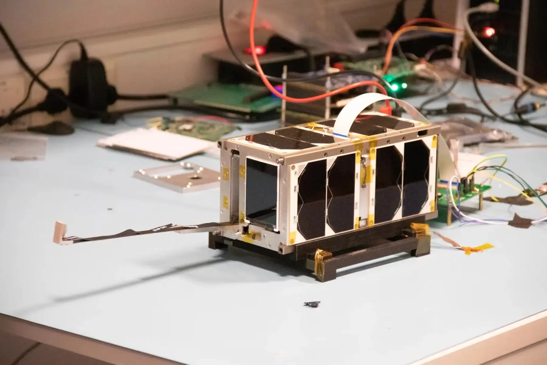 Picture of a 2U satellite in a lab. 